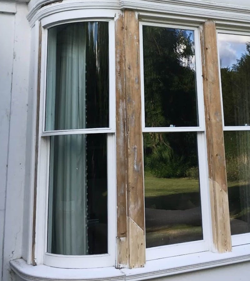 A curved sash bay with new timber spliced into its mullions, before lamination