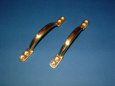 Two brass D-shaped sash window pull handles