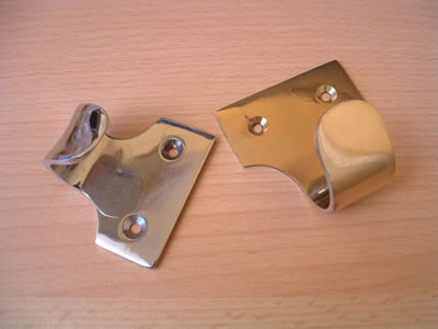 Two hook-type sash lifts, one chrome and one brass