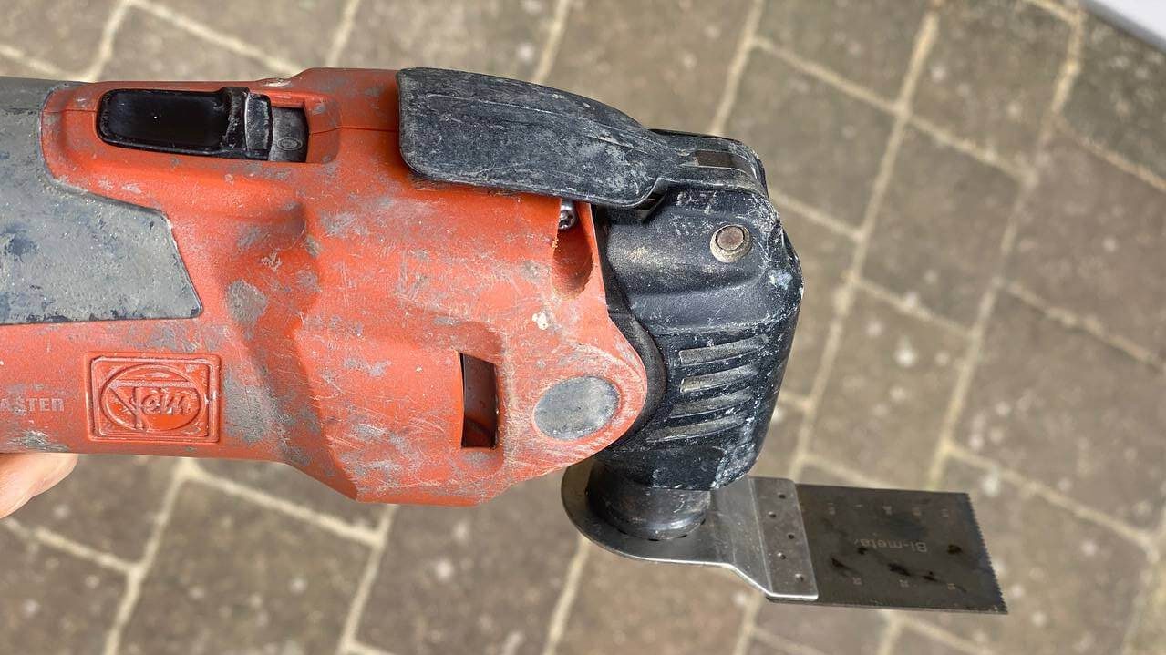 A Fein oscillating multi-tool with a saw blade fitted
