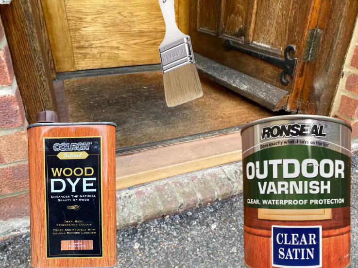 The new sill under the front door with tins of wood dye and outdoor varnish and a brush