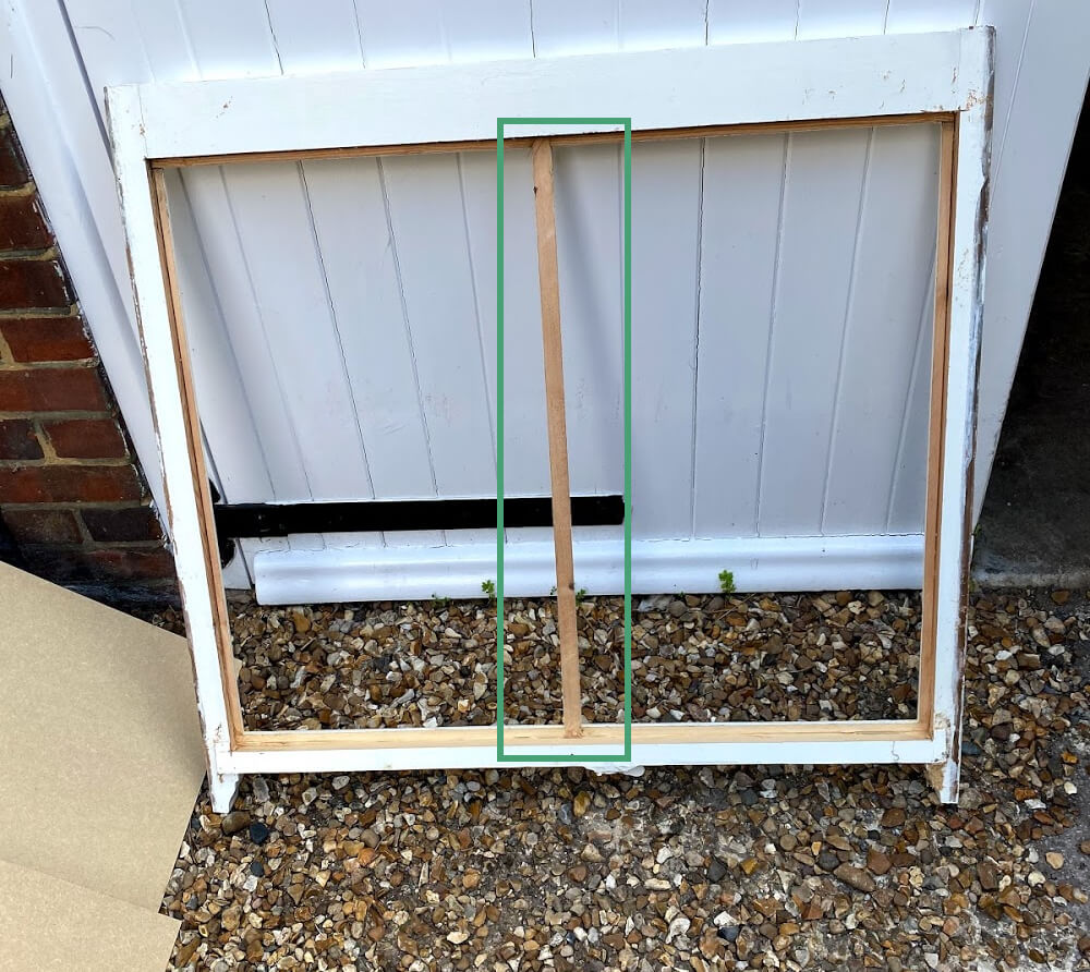 Rebated timber sash with the glass out and its original central glazing bar kept, highlighted by a green box