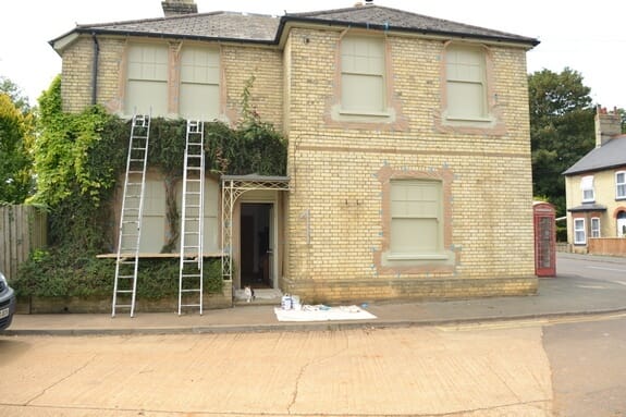 painted windows using paint sprayer from outside