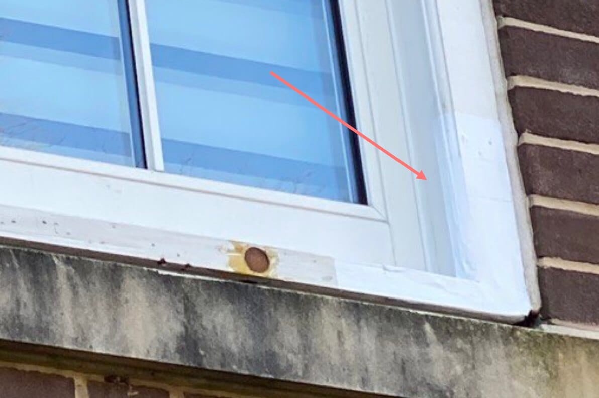 A refurbished sash window highlighted by a red arrow.