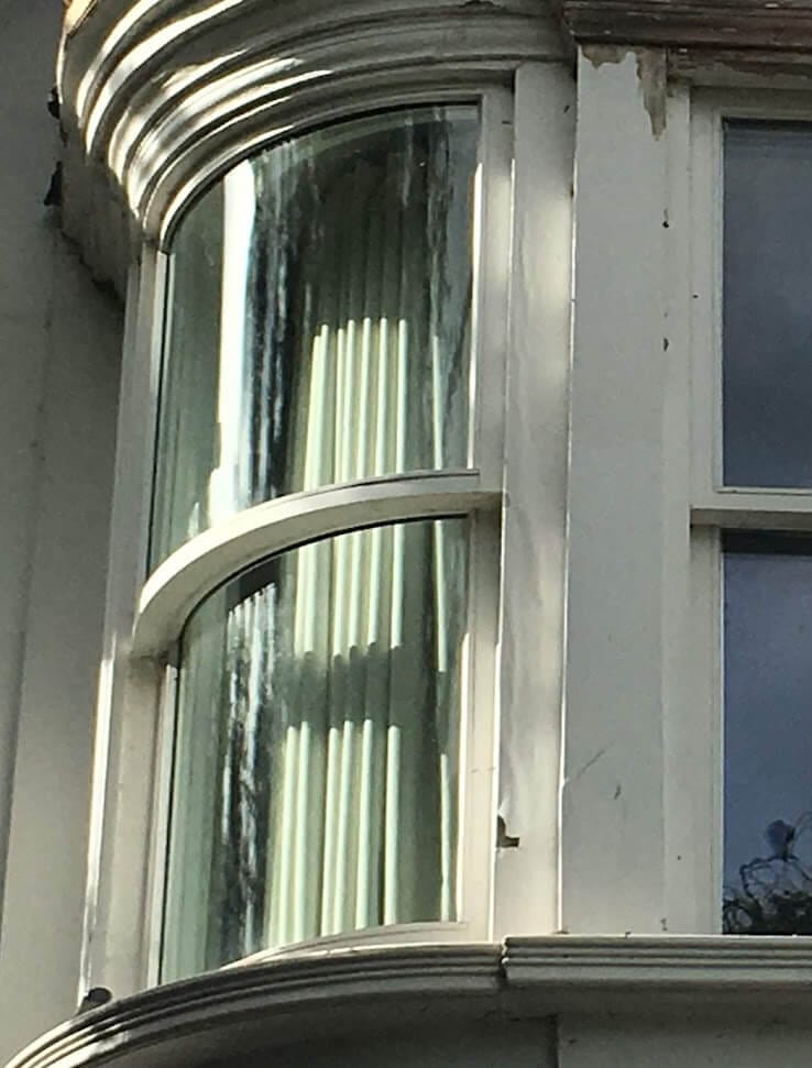 A one-over-one sash with curved glass in a curved bay
