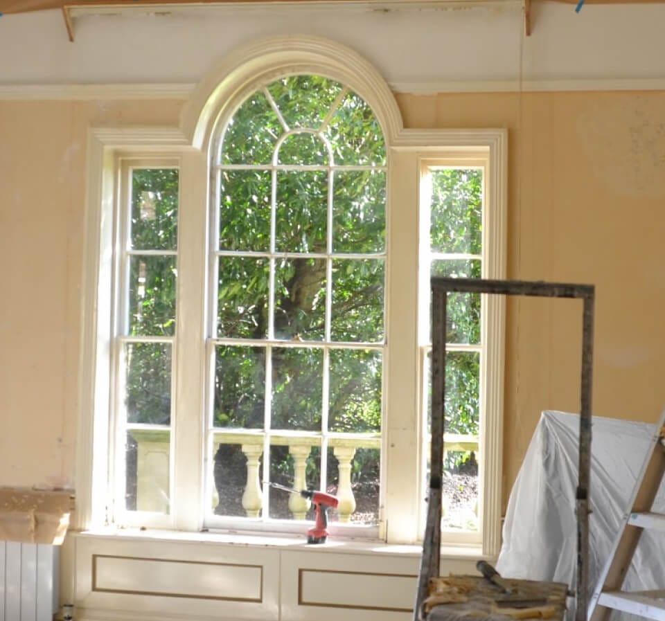 A Venetian window seen from inside during restoration: an arched centre sash between two narrow sashes