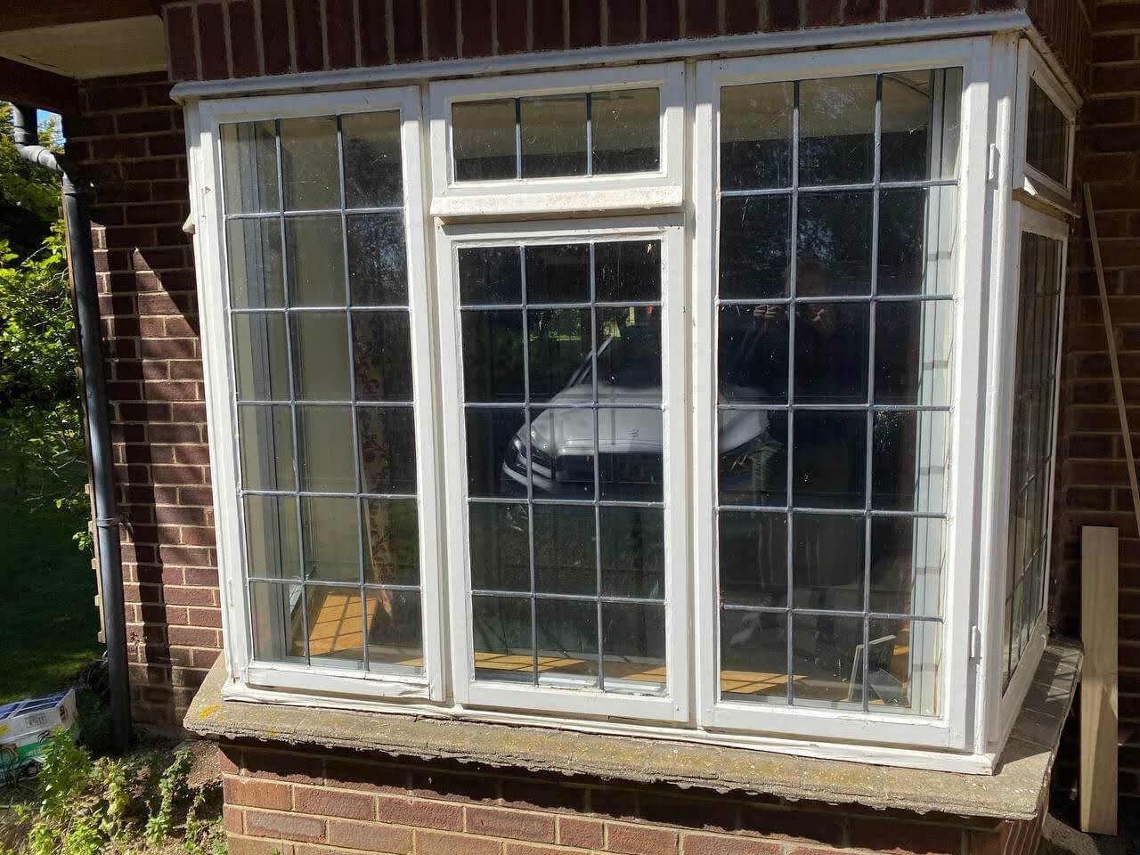 A restored bay window with a glass pane in front.