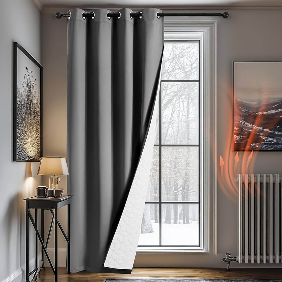 Grey thermal eyelet curtain with a white quilted lining over a tall window beside a radiator